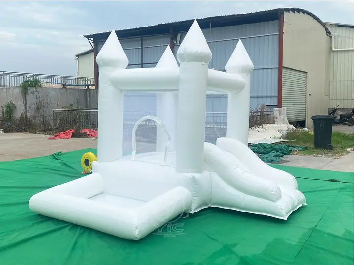 small white bounce house with ball pit