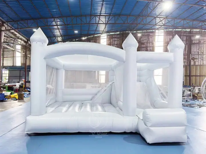 white bounce house with slide