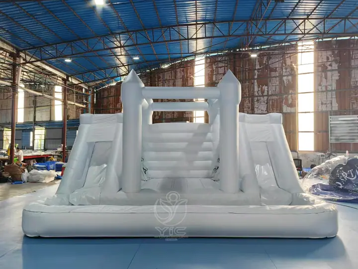 white bounce house with double slide