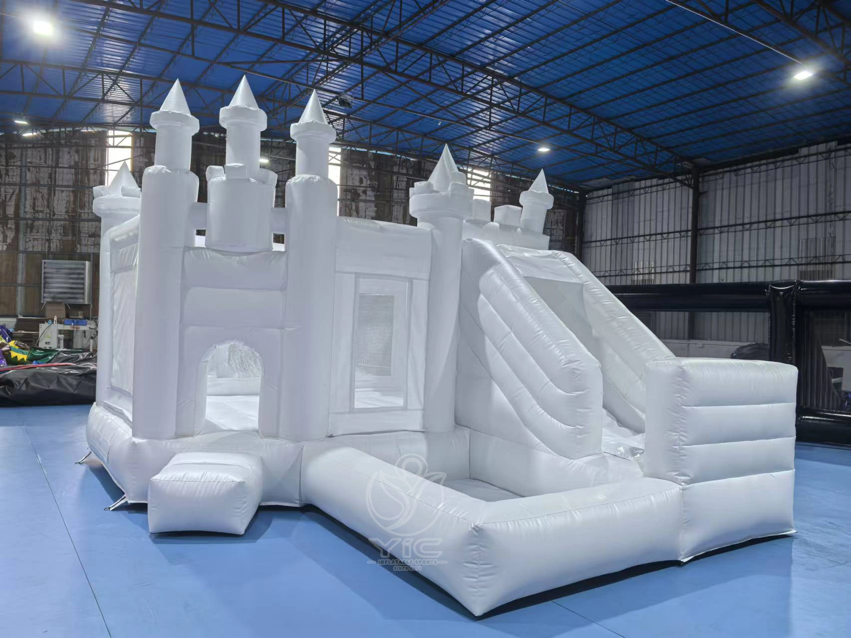 White jumping castle with slide and ball pit