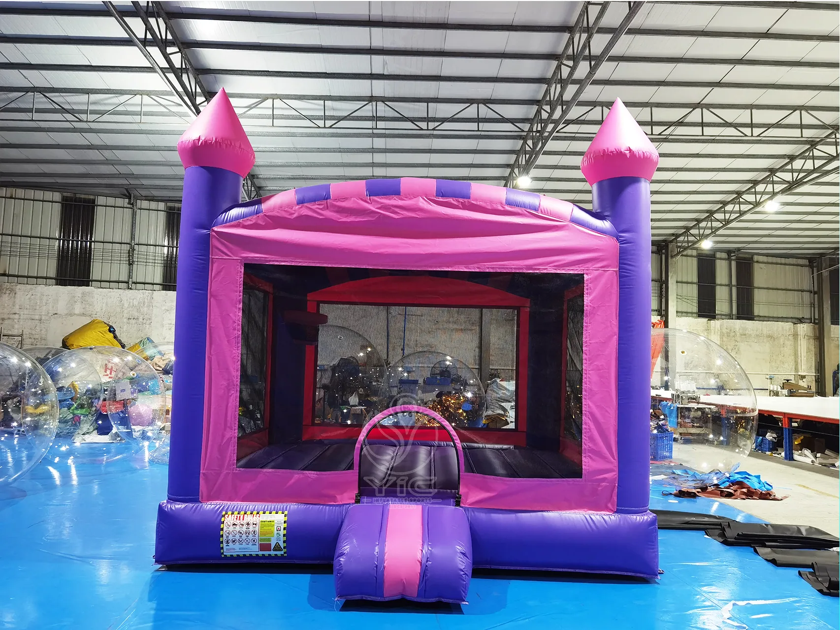 Pink and purple bounce house, a commercial bounce house and bouncy castle by YIC Inflatable Sports